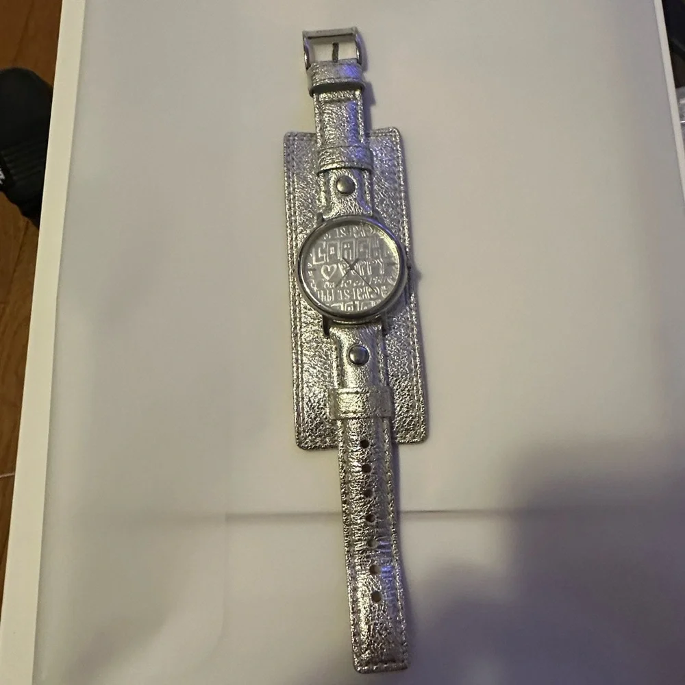 Coach Poppy cuff watch. Genuine leather with silver metallic‎ design. Vintage